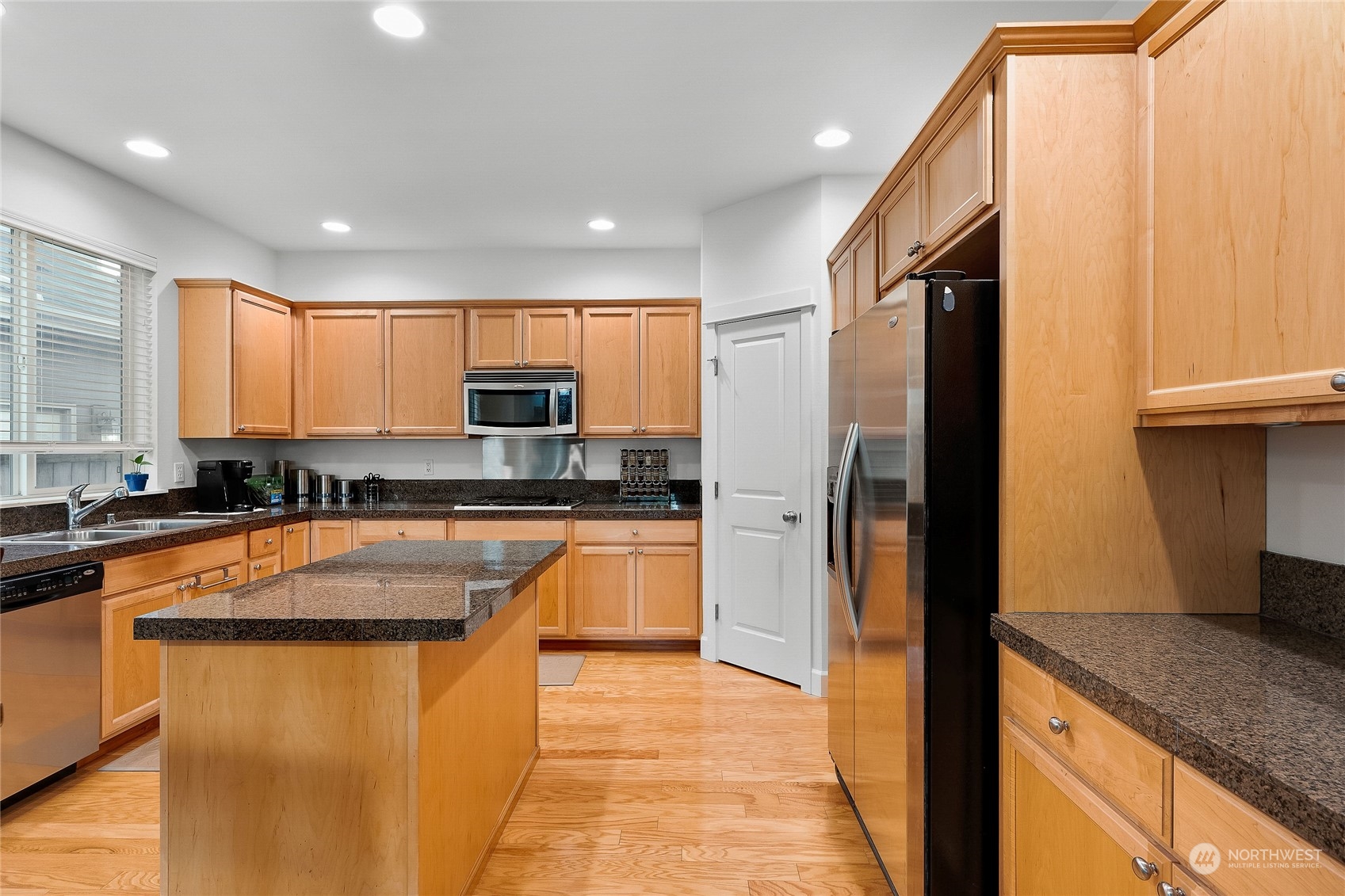 3412 171st Place Southeast Bothell, WA 98012 - Photo 15 of 40 a kitchen with stainless steel appliances granite countertop a refrigerator a sink a stove a microwave and island