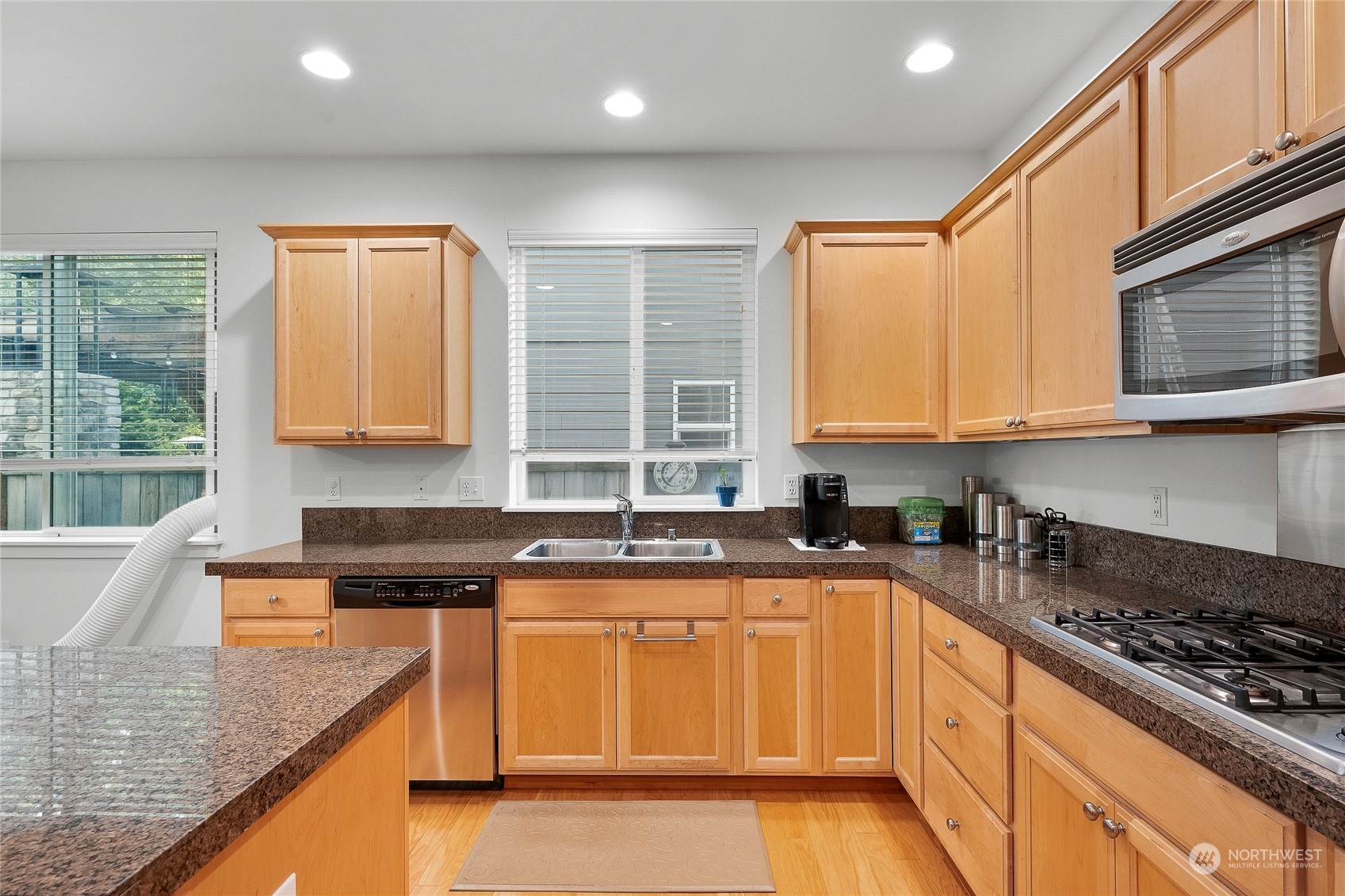 3412 171st Place Southeast Bothell, WA 98012 - Photo 17 of 40 a kitchen with stainless steel appliances granite countertop a sink stove and cabinets