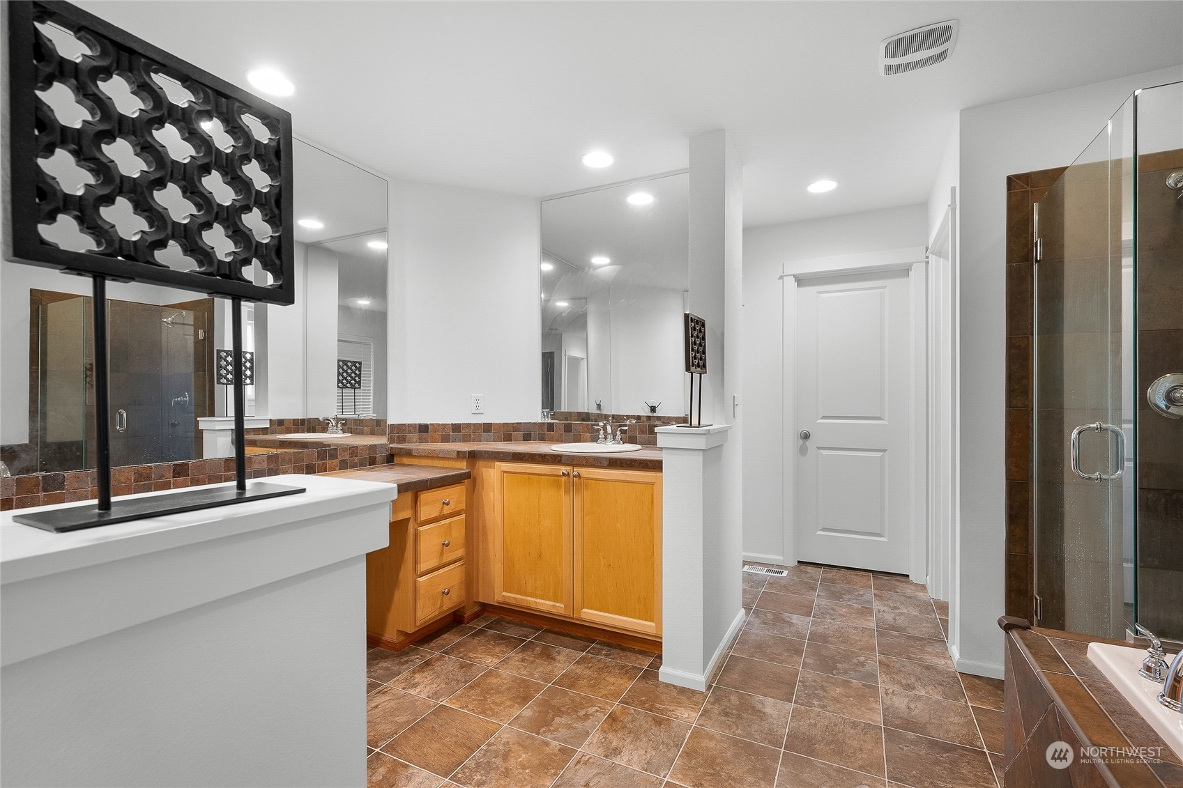 3412 171st Place Southeast Bothell, WA 98012 - Photo 32 of 40 a large bathroom with a large mirror vanity and shower
