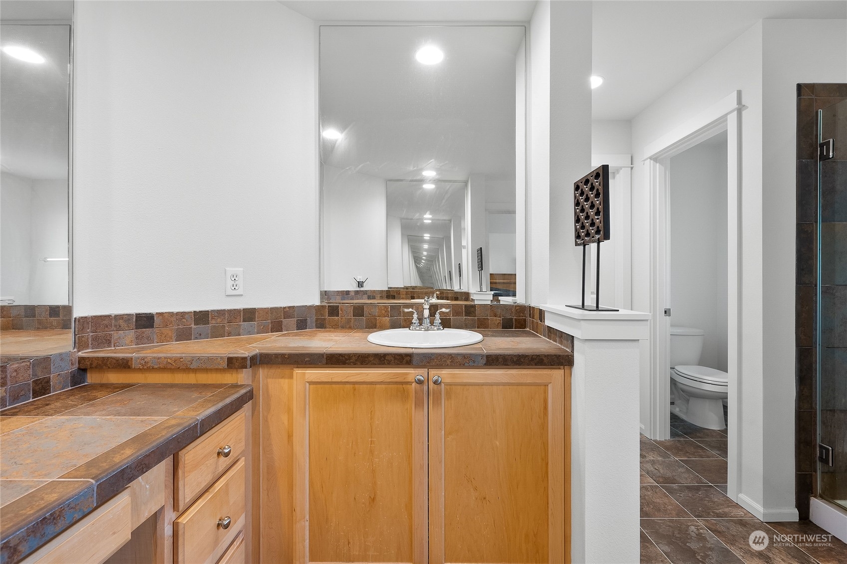 3412 171st Place Southeast Bothell, WA 98012 - Photo 34 of 40 a bathroom with a granite countertop sink a toilet and a mirror