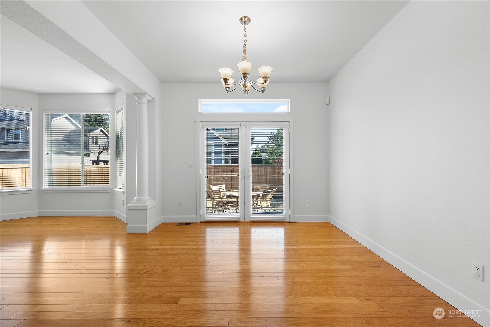 3412 171st Place Southeast Bothell, WA 98012 - Photo 10 of 40 a view of an empty room with wooden floor and a window
