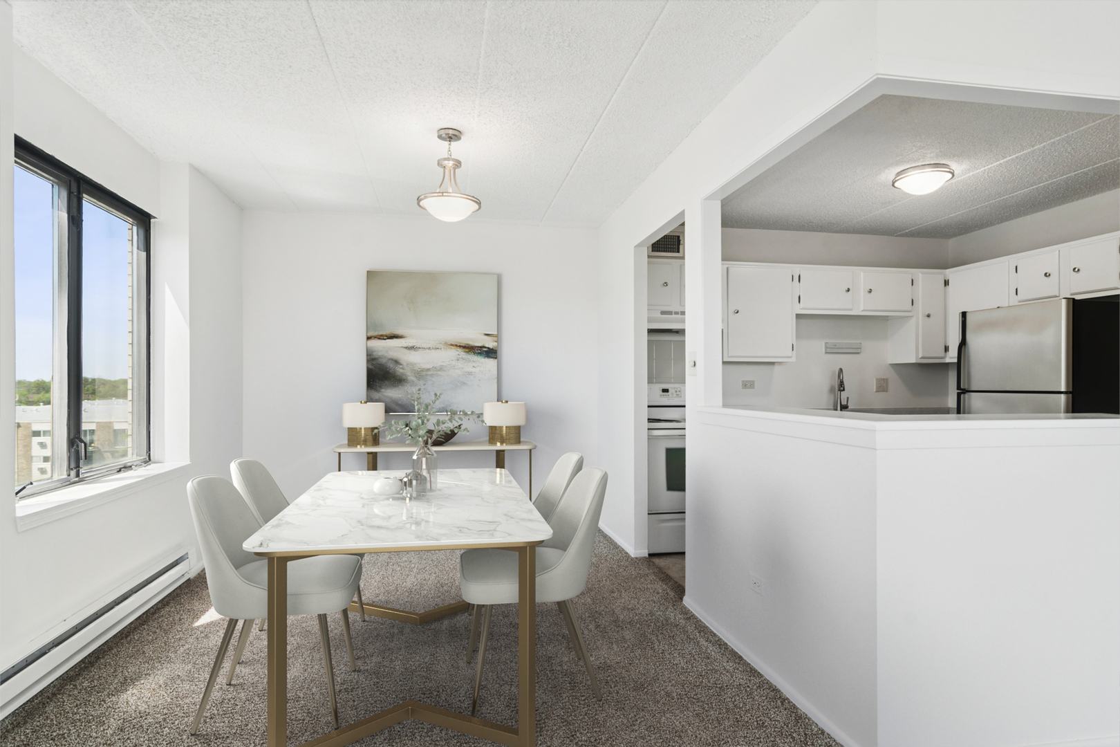 9701 North Dee Road, Unit 6N Niles, IL 60714 - Photo 6 of 13 a kitchen with kitchen island a table and chairs in it