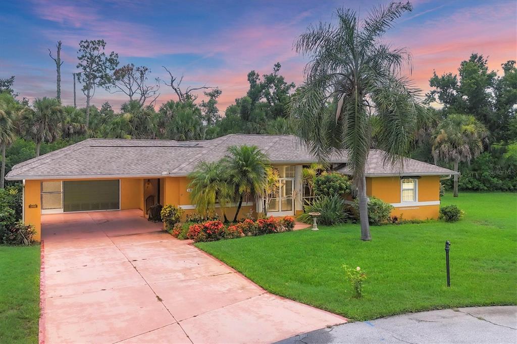 100 Siesta Road Rotonda West, FL 33947 - Photo 1 of 1 a front view of house with yard and green space