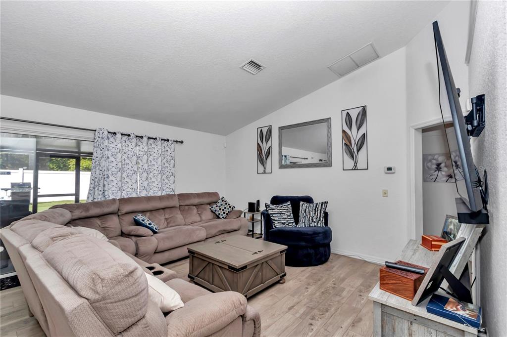 13800 Southwest 33rd Court Road Ocala, FL 34473 - Photo 20 of 42 a living room with furniture and a flat screen tv
