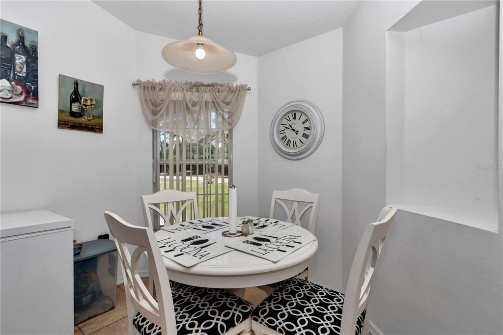 13800 Southwest 33rd Court Road Ocala, FL 34473 - Photo 22 of 42 a view of a dining room with furniture and wooden floor