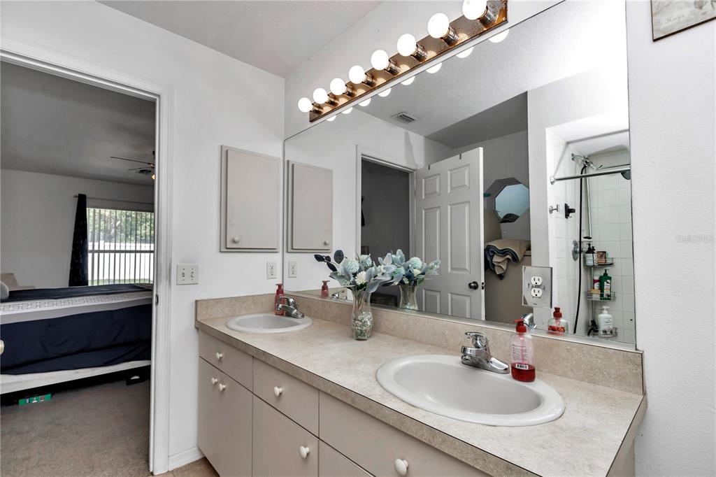 13800 Southwest 33rd Court Road Ocala, FL 34473 - Photo 27 of 42 a bathroom with a sink double vanity and a mirror