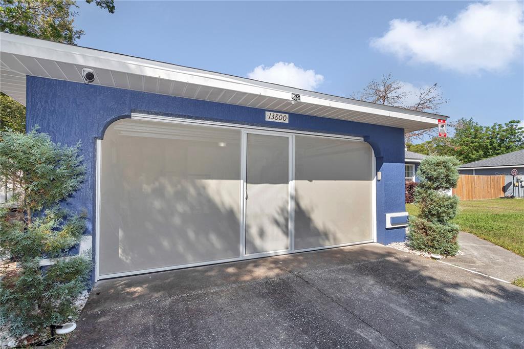 13800 Southwest 33rd Court Road Ocala, FL 34473 - Photo 5 of 42 a front view of a house with a yard and garage