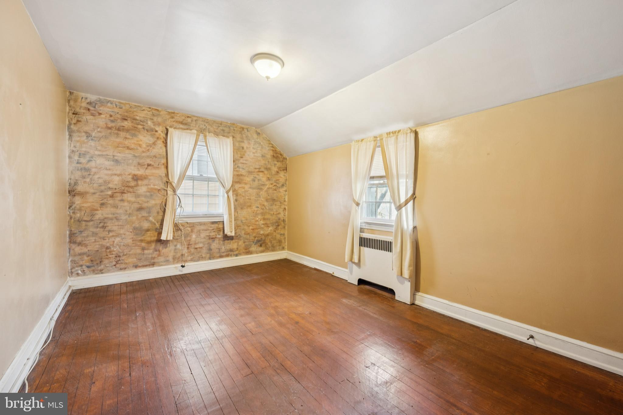 4817 Browning Road Pennsauken, NJ 08109 - Photo 17 of 25 an empty room with wooden floor and windows