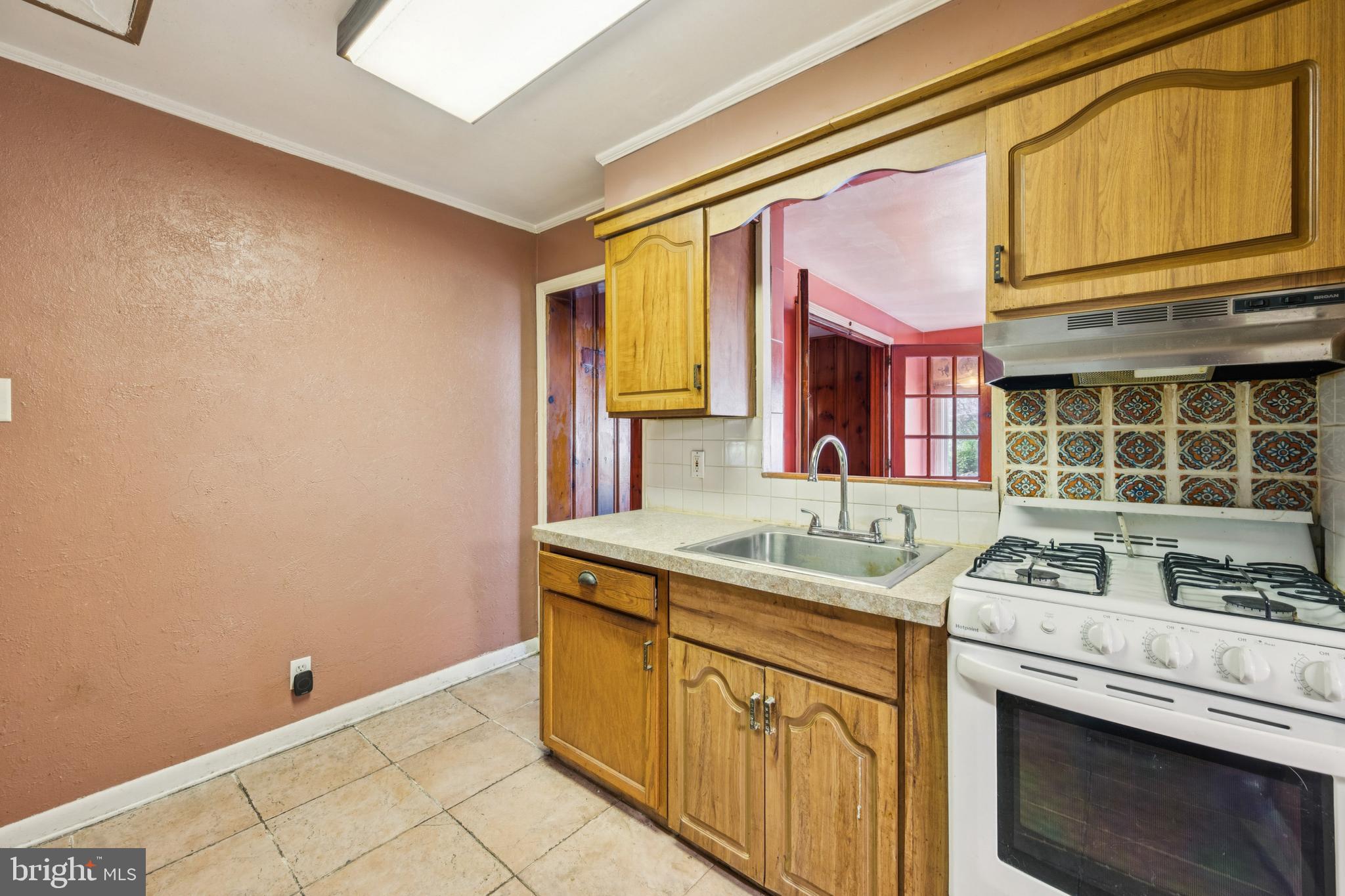 4817 Browning Road Pennsauken, NJ 08109 - Photo 21 of 25 a kitchen with granite countertop a sink cabinets and stainless steel appliances