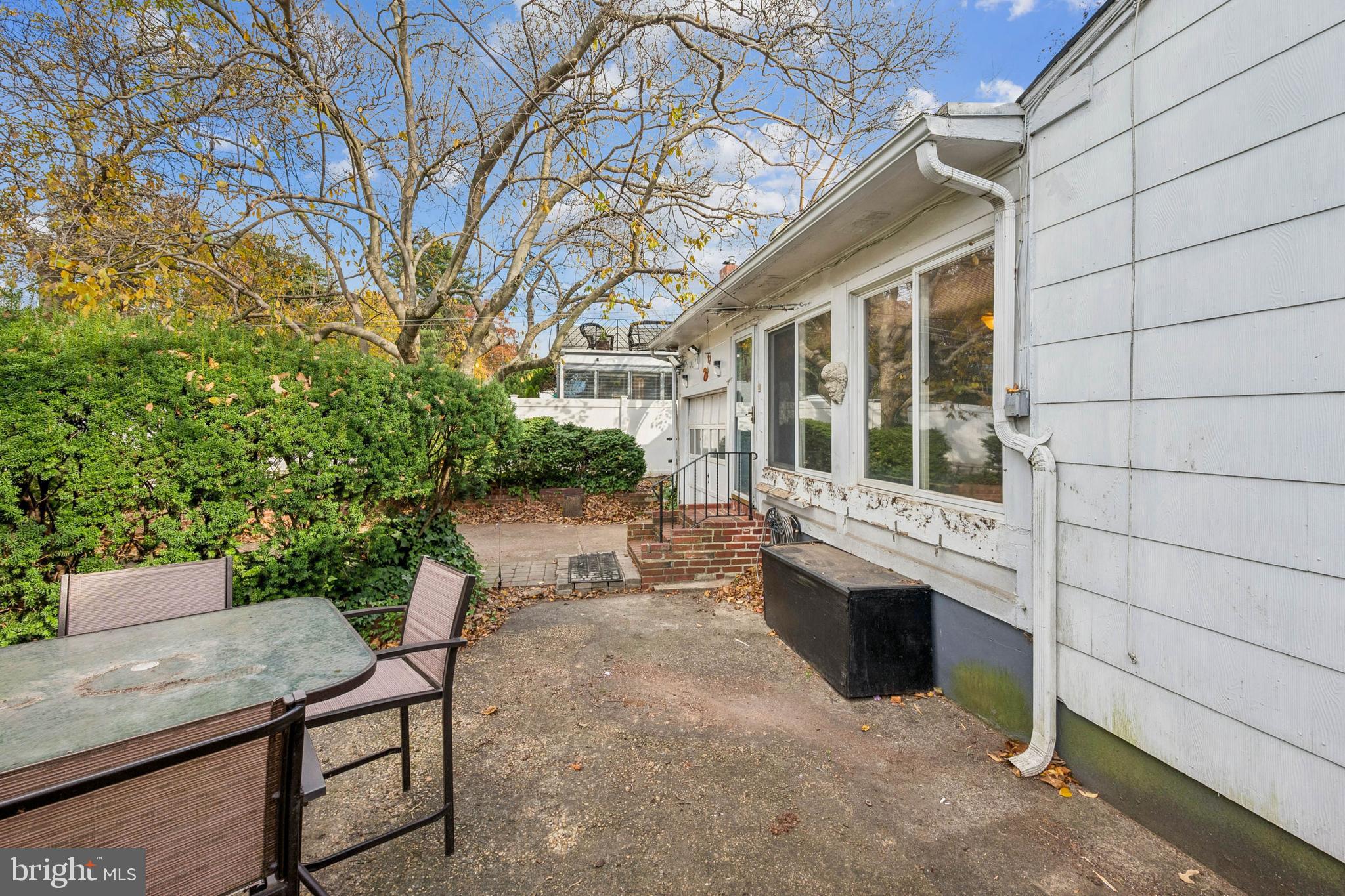 4817 Browning Road Pennsauken, NJ 08109 - Photo 22 of 25 a view of a patio with table and chairs with wooden fence and plants