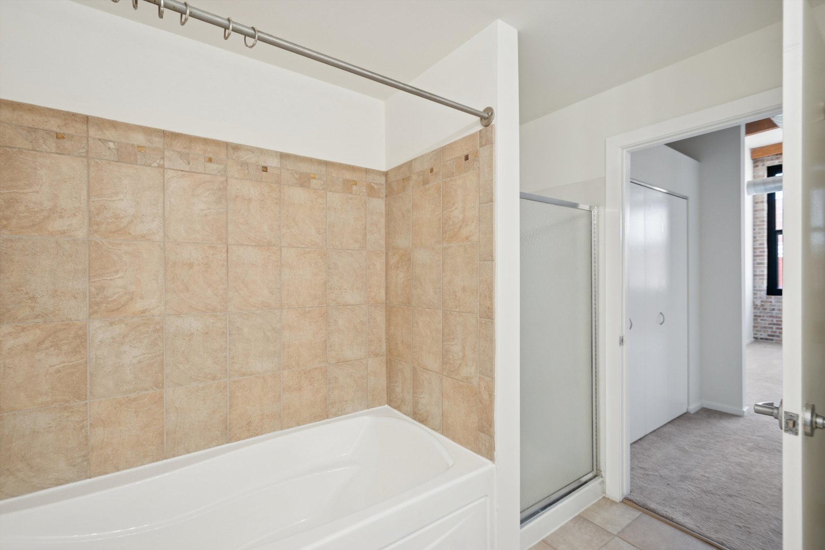 3500 South Sangamon Street, Unit 401 Chicago, IL 60609 - Photo 15 of 18 a bathroom with a bathtub and shower