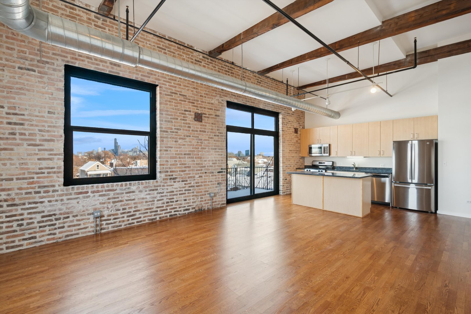 3500 South Sangamon Street, Unit 401 Chicago, IL 60609 - Photo 2 of 18 a view of an empty room with wooden floor and a window
