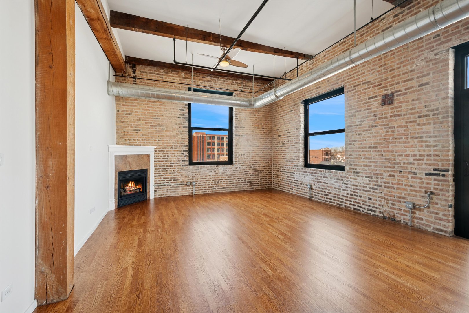 3500 South Sangamon Street, Unit 401 Chicago, IL 60609 - Photo 3 of 18 a view of an empty room with wooden floor and a window