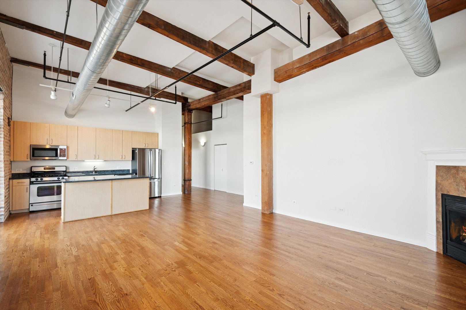 3500 South Sangamon Street, Unit 401 Chicago, IL 60609 - Photo 4 of 18 a large kitchen with white cabinets and wooden floor