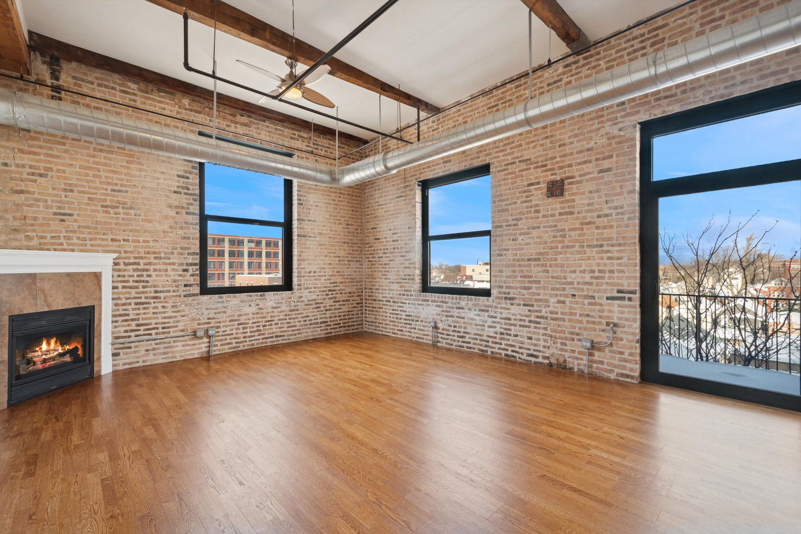 3500 South Sangamon Street, Unit 401 Chicago, IL 60609 - Photo 5 of 18 a view of an empty room with wooden floor and a window