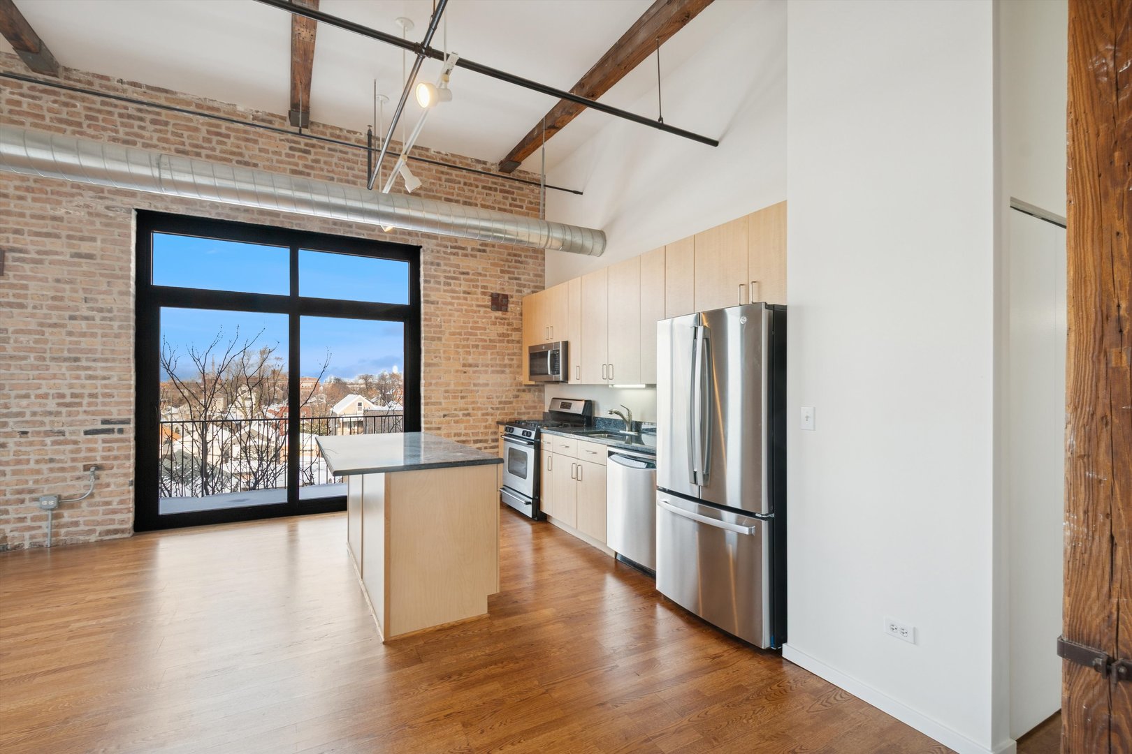 3500 South Sangamon Street, Unit 401 Chicago, IL 60609 - Photo 7 of 18 a kitchen with stainless steel appliances a refrigerator and wooden floor