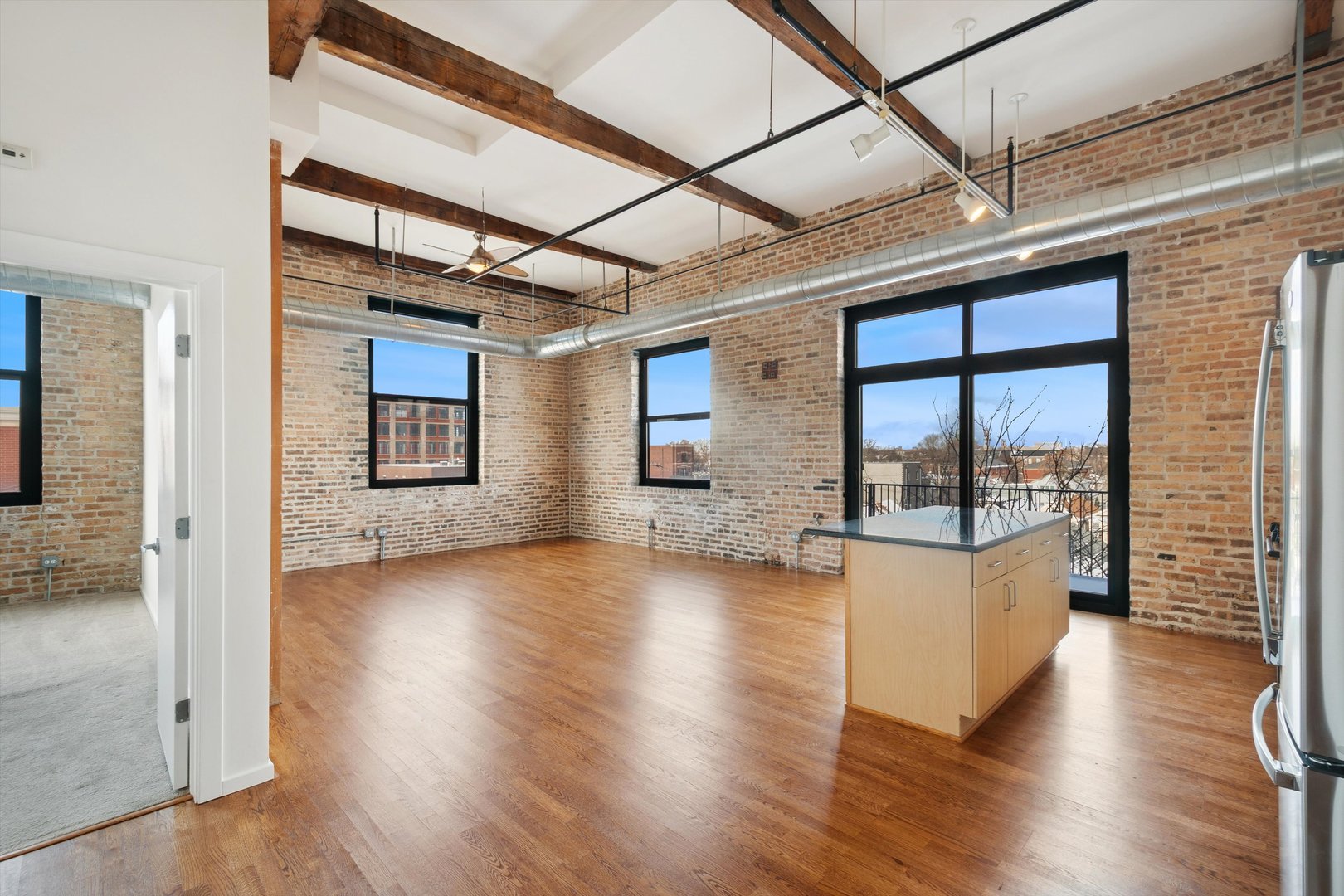 3500 South Sangamon Street, Unit 401 Chicago, IL 60609 - Photo 8 of 18 a view of an empty room with wooden floor and a window