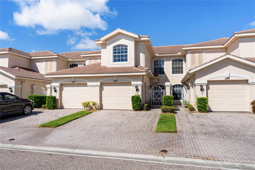a front view of a house with a yard and garage
