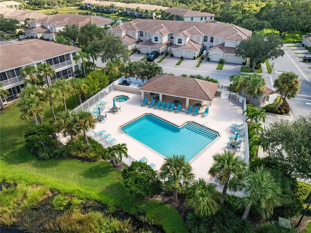 an aerial view of a house with garden space and lake view