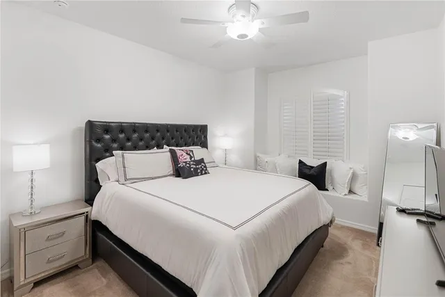 a bedroom with a bed and a lamp with the window