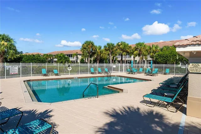 a view of a swimming pool with a patio and a garden