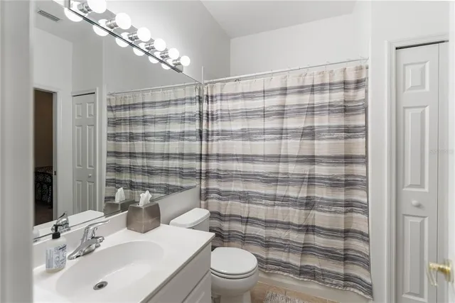 a bedroom with a bed and a television