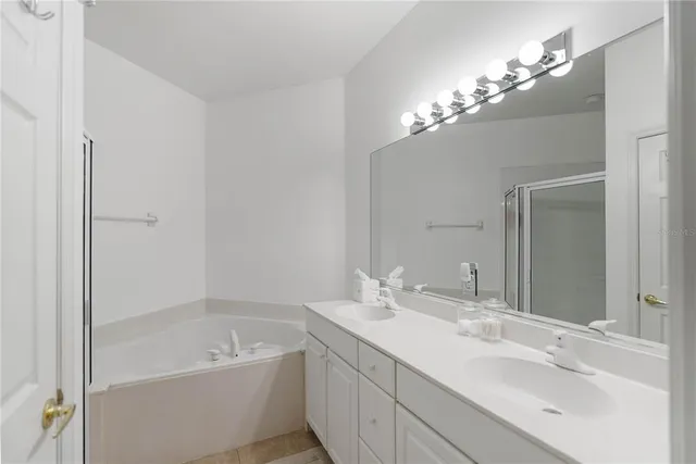 a bathroom with a double vanity sink and a mirror