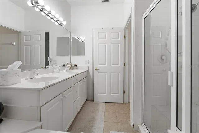 a bedroom with a large bed and a flat screen tv