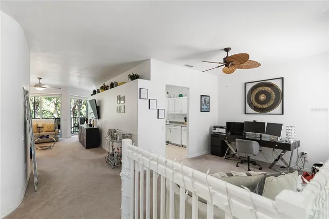 a living room with furniture and ceiling fan