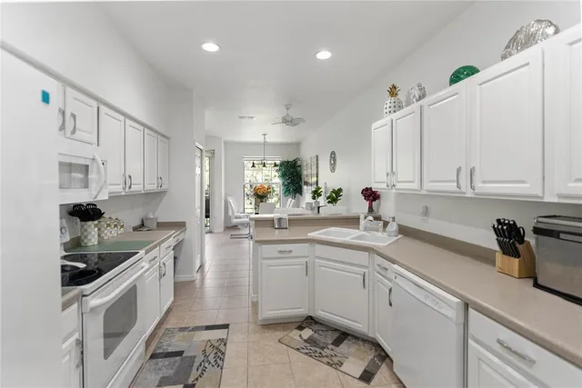 a kitchen with stainless steel appliances kitchen island granite countertop a sink and cabinets