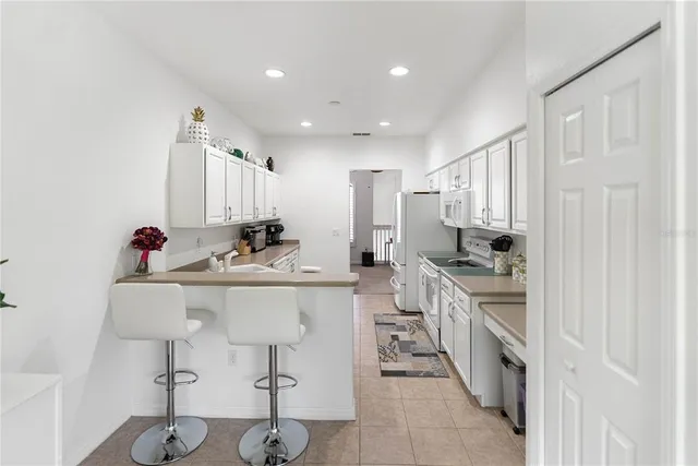 a dining room with furniture and a chandelier
