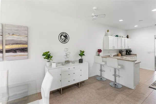 a dining room filled furniture and a chandelier