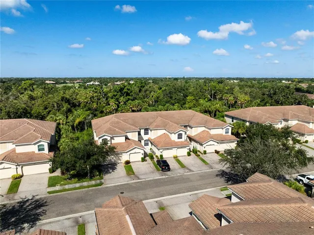 an aerial view of a house with a yard