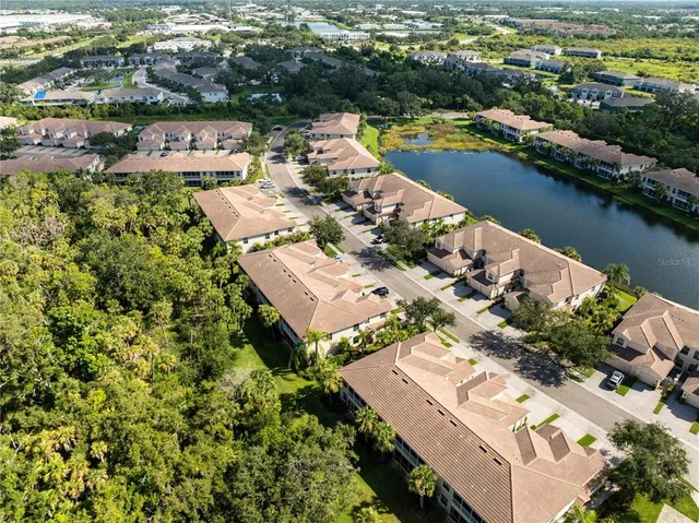 an aerial view of a houses with a lake view