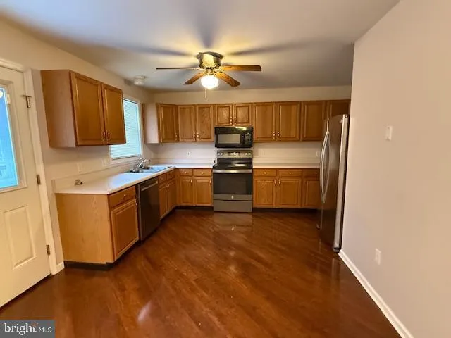 a kitchen with stainless steel appliances granite countertop a stove and a sink