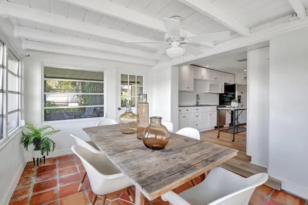 a kitchen with a table chairs and wooden floor