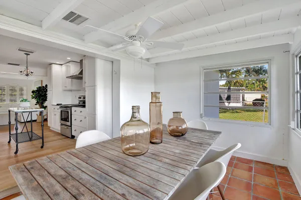 a view of a dining room with furniture and a window