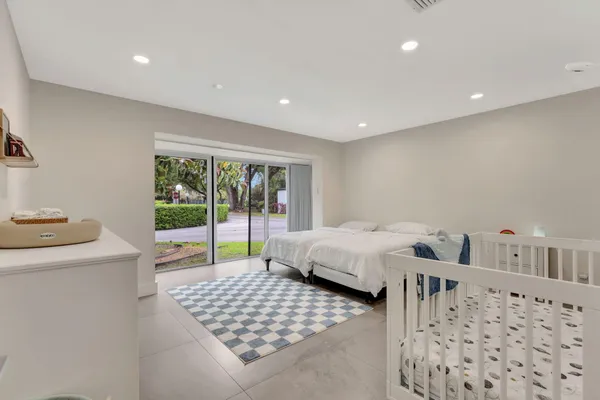 a bedroom with furniture and a large window