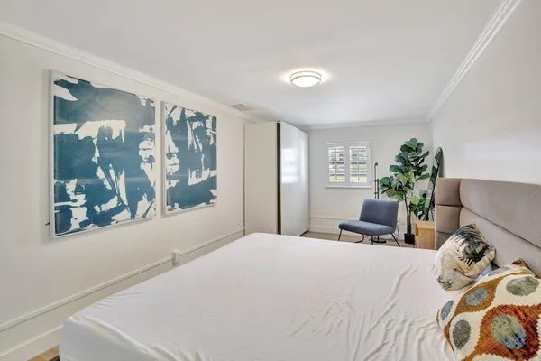 a bedroom with a large bed and a window