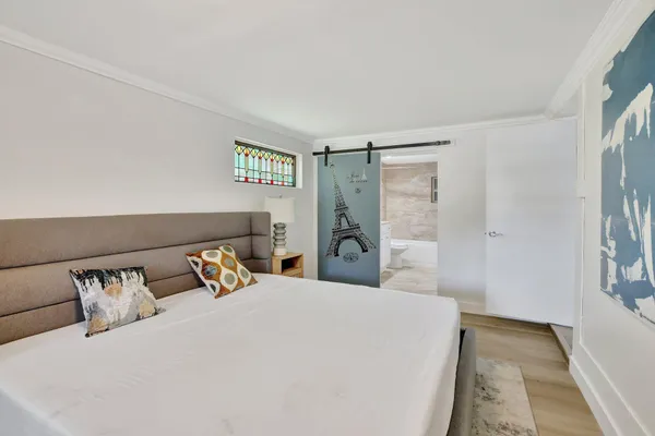 a bedroom with a bed and a night stand