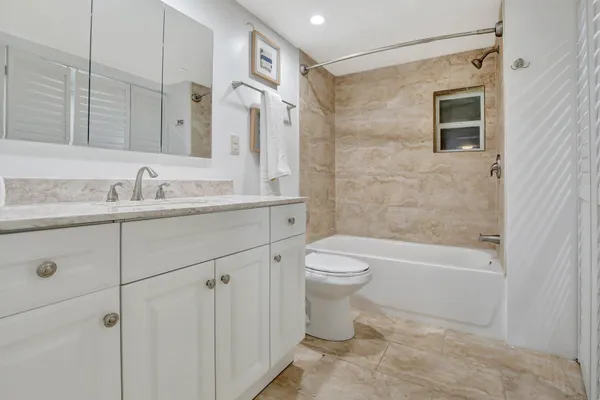 a bathroom with a double vanity sink toilet and shower