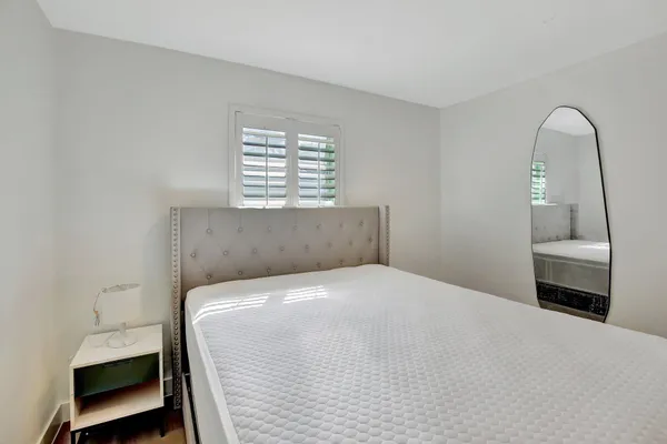 a bedroom with a bed and a window