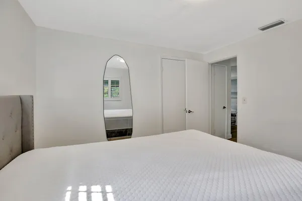 a bedroom with a bed and a window