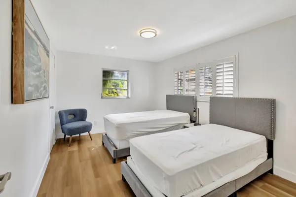 a bedroom with a bed and a chair