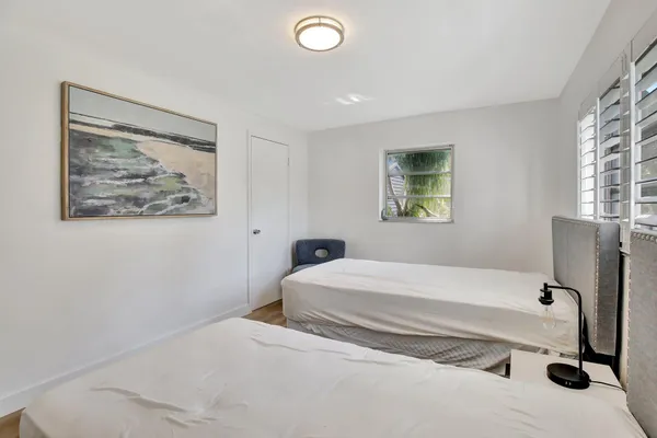 a bedroom with a bed and a painting on the wall