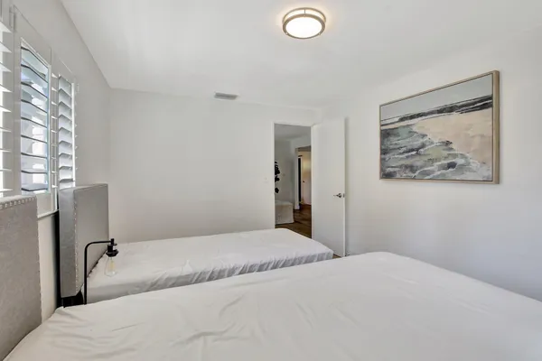 a bedroom with a bed and a painting on the wall