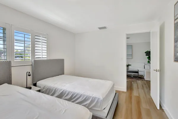 a bedroom with a bed and a lamp on table