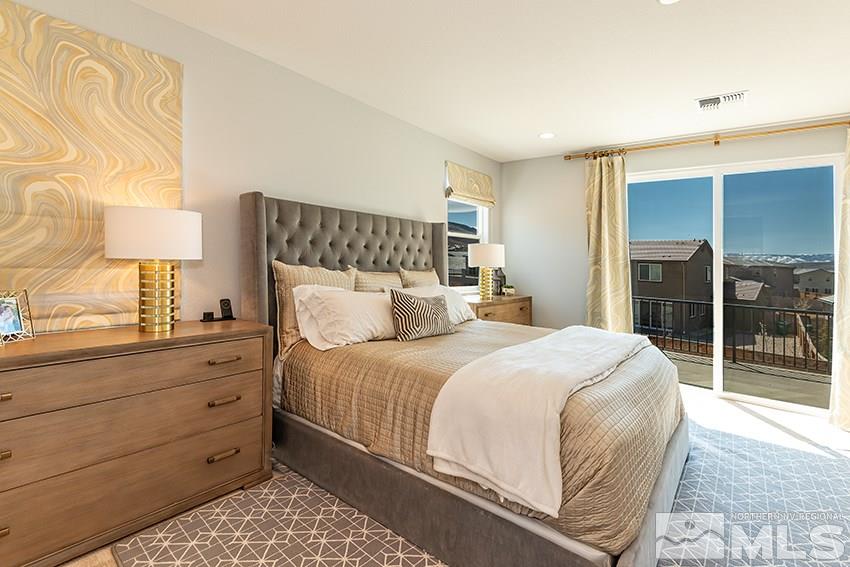 3190 Show Jumper Lane Reno, NV 89521 - Photo 9 of 32 a bedroom with a bed and a lamp