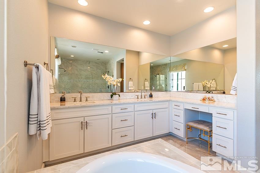 3190 Show Jumper Lane Reno, NV 89521 - Photo 10 of 32 a large bathroom with a large mirror vanity and shower