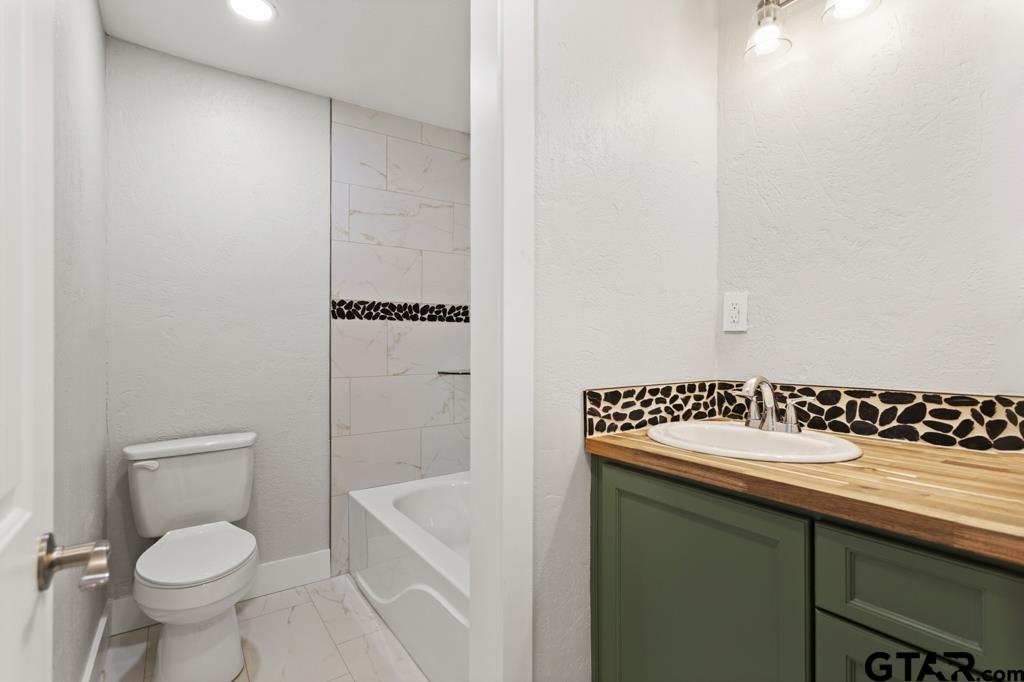 2819 New Copeland Road Tyler, TX 75701 - Photo 23 of 39 a bathroom with a sink toilet and shower